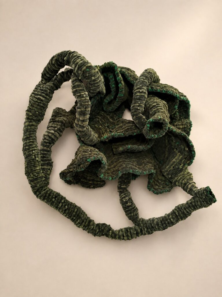 Olive-green looping coiled form. Pipe cleaner sculpture by Ted Fullwood
