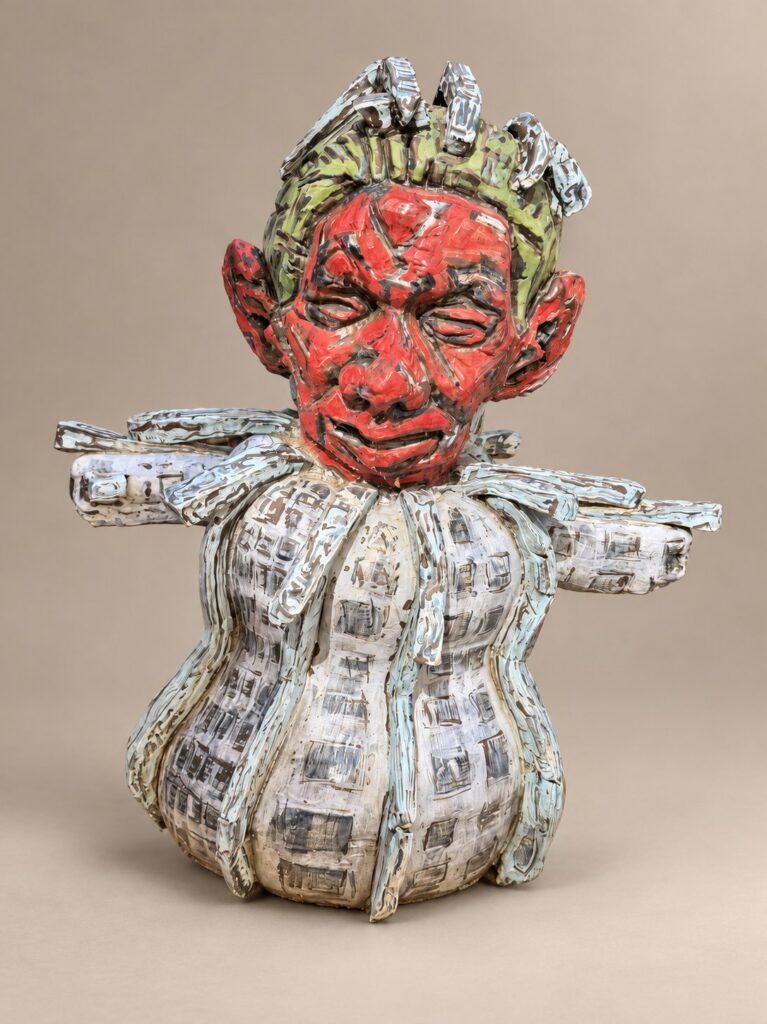 Red-faced figure with a white ribbed body. Ceramic sculpture by Ted Fullwood